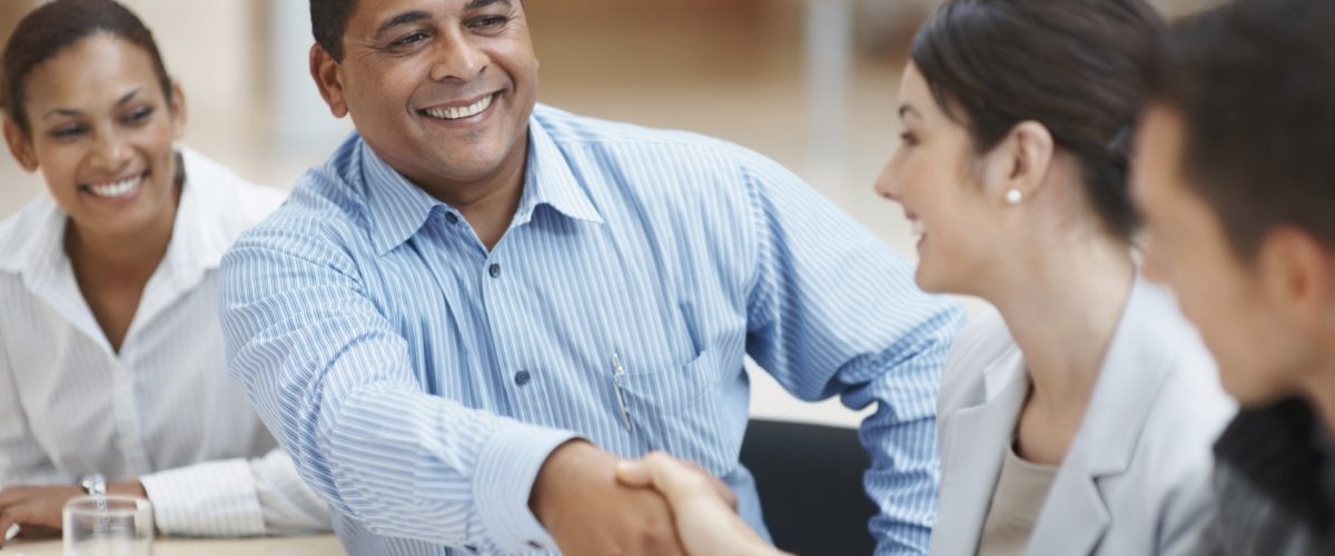 Mature man handshaking with partner after striking a business deal